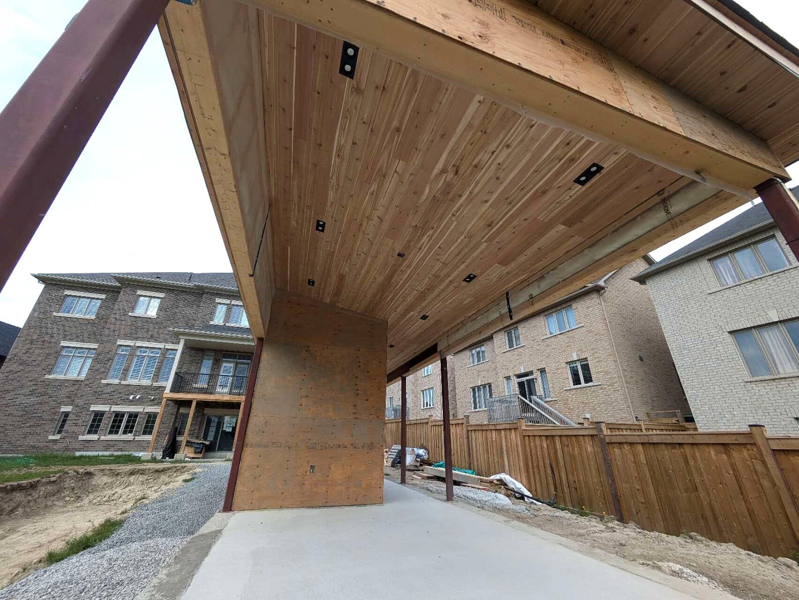 Wood plank soffit ceiling and steel post of a pool cabana