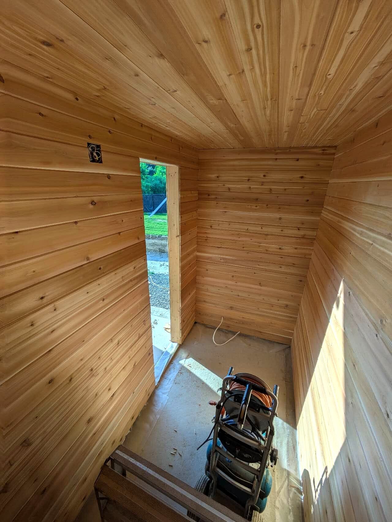 Pool cabana side view with sheathed walls under a slanted roof